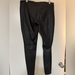 Black smooth texture with mid knee seam faux leather pants